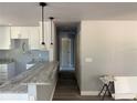 Open kitchen design with granite counters, pendant lighting, and wood-look floors at 5411 Nw 7Th Pl, Ocala, FL 34482