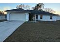 Single-story home with attached garage and grassy front yard at 8512 Sw 136Th Pl, Ocala, FL 34473