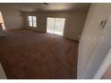 Bright living room featuring sliding glass doors and carpet at 8512 Sw 136Th Pl, Ocala, FL 34473