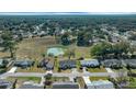 Wide aerial view of the community highlighting the neighborhood homes and the serene pond in the backyard at 8822 Sw 108Th St, Ocala, FL 34481