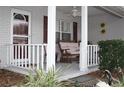 Relaxing front porch with white columns and seating at 9662 Sw 97Th Ln, Ocala, FL 34481