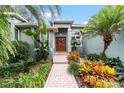 Inviting front entrance with lush landscaping and brick pathway at 1105 Se 48Th Ave, Ocala, FL 34471