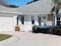 White house with attached garage and landscaped yard at 11441 Sw 68Th Ct, Ocala, FL 34476