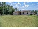 Elevated home with a spacious backyard and covered patio at 13076 Sw 38Th Ter, Ocala, FL 34473