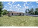 Backyard with grassy lawn and covered patio at 13076 Sw 38Th Ter, Ocala, FL 34473