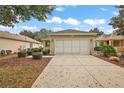 Single-story home with attached garage and landscaped front yard at 13309 Se 92Nd Court Rd, Summerfield, FL 34491