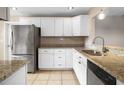 Kitchen with white cabinets, granite countertops, and stainless steel appliances at 1903 Se 37Th Court Cir, Ocala, FL 34471