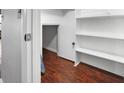 Small storage room with white shelving and wood-look flooring at 1903 Se 37Th Court Cir, Ocala, FL 34471