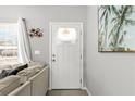 Front door with a window and decorative curtain at 19173 St Benedict Dr, Dunnellon, FL 34432