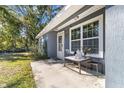 Small front porch with a table and seating area at 19173 St Benedict Dr, Dunnellon, FL 34432