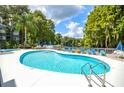 Inviting kidney-shaped swimming pool with lounge chairs at 20820 River Dr # B17, Dunnellon, FL 34431