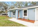 Inviting front entrance showcasing a cozy porch at 477 Marion Oaks Golf Rd, Ocala, FL 34473