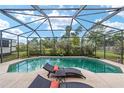 Relaxing pool area with screened enclosure and lounge chairs at 4864 Sw 103Rd Street Rd, Ocala, FL 34476