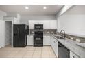 Modern kitchen featuring granite countertops and black appliances at 4947 Sw 45Th Cir, Ocala, FL 34474