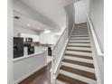 View of staircase and kitchen with modern appliances at 4947 Sw 45Th Cir, Ocala, FL 34474