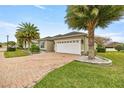 House exterior showcasing brick driveway and landscaping at 5015 Belted Kingfisher Dr, Oxford, FL 34484