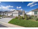 Two-car garage and landscaped front yard with brick pavers at 5395 Nw 46Th Ln, Ocala, FL 34482