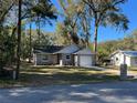 Newly built home with gray siding and a spacious front yard at 6450 Nw 57Th Ave, Ocala, FL 34482