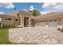 Large three-car garage and a stone accented entryway at 7549 Nw 33Rd Pl, Ocala, FL 34482