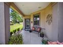 Covered porch with a bench, offering a relaxing spot to enjoy the outdoors at 7617 Sw 96Th Avenue Rd, Ocala, FL 34481