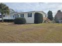 Single-story manufactured home with deck and fenced yard at 8009 County Road 109D, Lady Lake, FL 32159