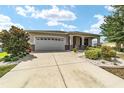 One-story home with landscaped yard and covered porch at 8230 Sw 78Th Cir, Ocala, FL 34476