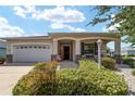 One-story home with landscaped yard and covered porch at 8230 Sw 78Th Cir, Ocala, FL 34476