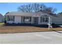 Front view of a single-story house with white siding and landscaping at 8340 Sw 108Th Place Rd, Ocala, FL 34481