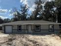 Charming single-story home featuring a neutral color scheme and an attached single car garage at 10538 Se 50Th Ave, Belleview, FL 34420