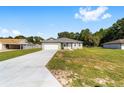 Inviting single-story home with a spacious driveway and manicured lawn, perfect for Gathering living at 10871 Sw 62Nd Avenue Rd, Ocala, FL 34476