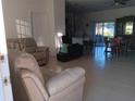 Spacious living room with tile floors and adjacent dining area at 10871 Sw 62Nd Avenue Rd, Ocala, FL 34476
