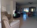 Spacious living room with tile floors and adjacent dining area at 10871 Sw 62Nd Avenue Rd, Ocala, FL 34476