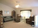 Spacious living room with couches, recliner chairs, and built in shelving at 11752 Sw 139Th St, Dunnellon, FL 34432