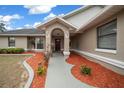 Inviting front entryway with a walkway and landscaping at 14050 Sw 32Nd Terrace Rd, Ocala, FL 34473