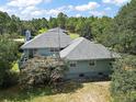 Aerial view showcases the home's large backyard and surrounding landscape at 22777 Sw Surf Blvd, Dunnellon, FL 34431