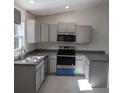 Modern kitchen with stainless steel appliances at 24162 Nw Hemlock Ave, Dunnellon, FL 34431