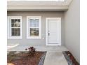 Home exterior front entrance with white door and gray siding at 281 Marion Oaks Crse, Ocala, FL 34473
