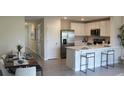 Open concept kitchen and dining area with modern finishes at 3300 Bertram Rd, Wildwood, FL 34785