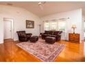 Spacious living room with hardwood floors, leather furniture, and a ceiling fan at 3333 Nw 47Th Ct, Ocala, FL 34482