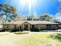 Brick ranch house with a landscaped yard at 3569 Sw 49Th Ter, Ocala, FL 34474