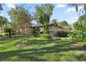 Landscaped yard with lush green grass and tropical plants at 3856 Ne 19Th Street Cir, Ocala, FL 34470