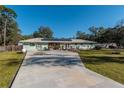 House with solar panels and a long driveway at 4005 Sw 183Rd Ter, Dunnellon, FL 34432