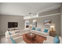 Bright living room featuring comfortable seating and large TV at 4677 Sw 166Th Loop, Ocala, FL 34473