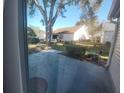 View of backyard with patio and large tree at 529 Alcazar Ct, The Villages, FL 32159