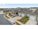 Two-story house with a front porch, two-car garage, and landscaped yard; aerial view at 6115 Sw 74Th Ct, Ocala, FL 34474