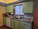 Bright kitchen with light green cabinets and granite countertops at 8211 Sw 106Th St, Ocala, FL 34481