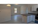 Open kitchen features modern white cabinets and granite countertops at 963 Sw Temple Heights Ct, Dunnellon, FL 34431