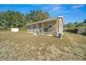 Single-story house with a shed in the backyard at 17175 Ne Jacksonville Rd, Citra, FL 32113