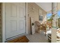 Front door entrance with a welcome mat and decor at 17175 Ne Jacksonville Rd, Citra, FL 32113