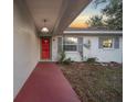 Inviting front entrance with red door and walkway at 37 Willow Run, Ocala, FL 34472